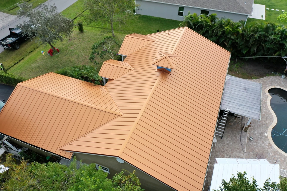 Completed roof with gold metal sheets providing long-lasting protection and striking aesthetic.