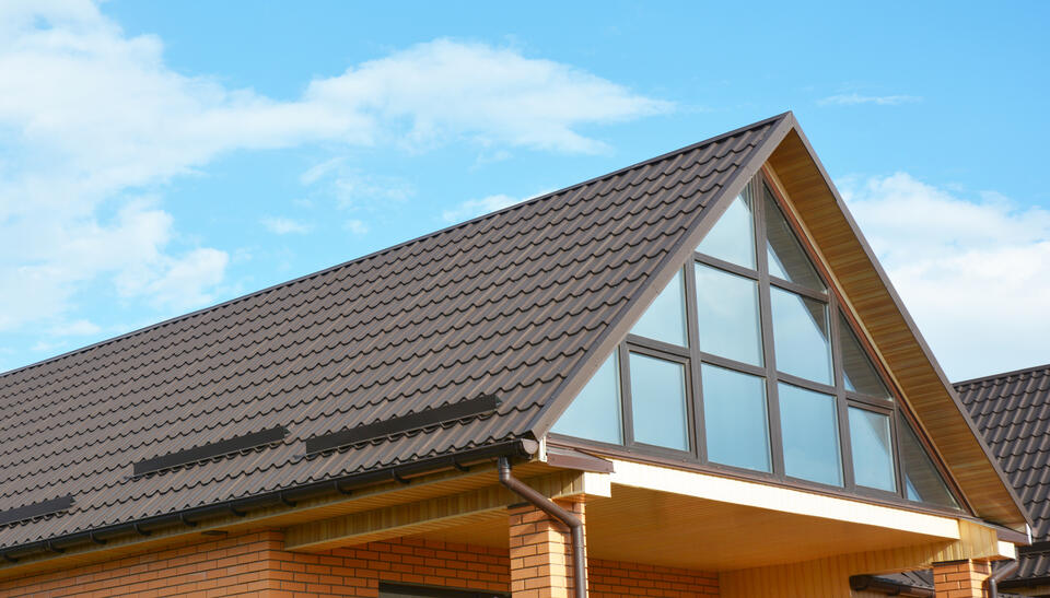 metal roofing palm beach fl-brown metal shingles on a brick house