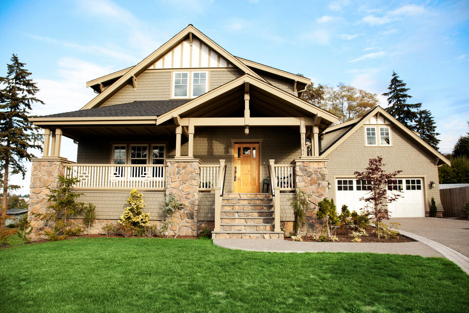 roofing palm beach fl-tan sided house with dark gray shingles