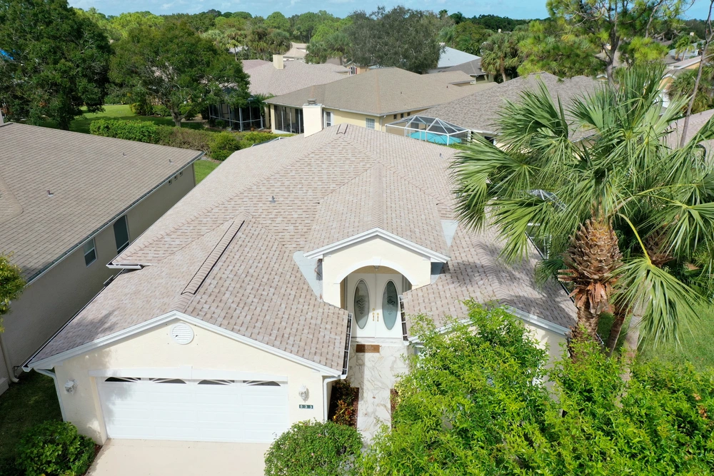 Completed tan shingle roof installation project delivering protection and aesthetic appeal.