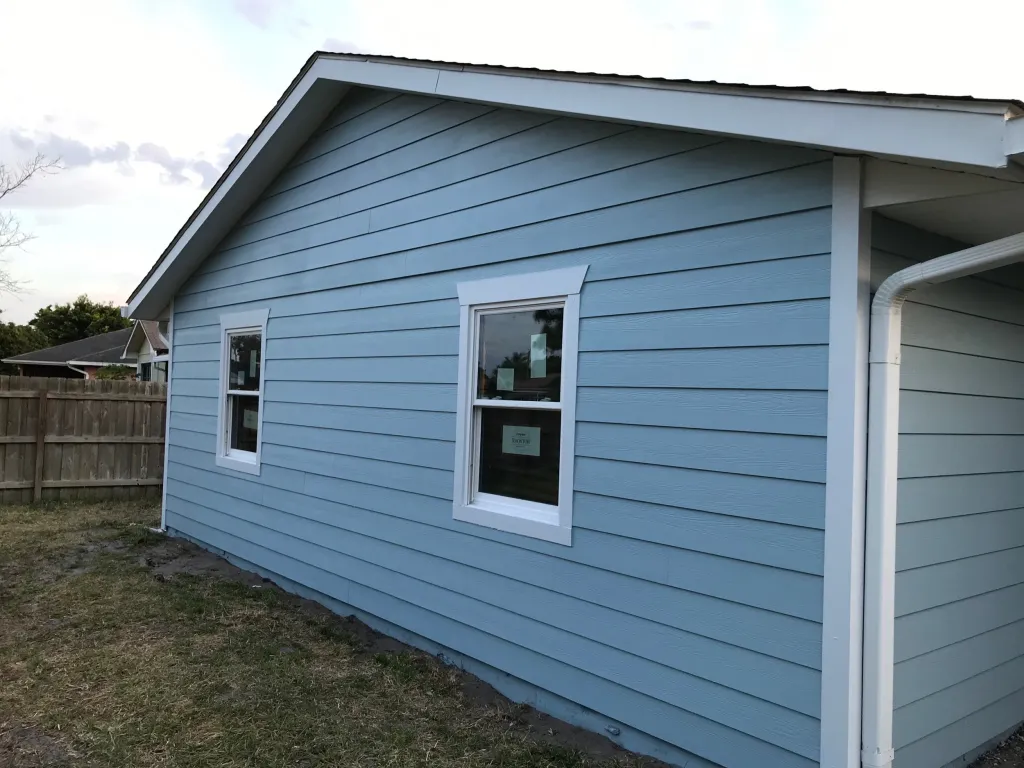 Completed roof with impact-resistant windows and siding enhancing safety and energy efficiency.