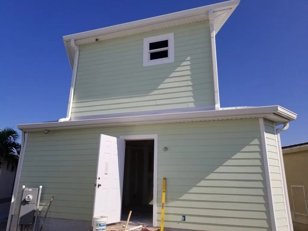 Installing roof gutters to provide safe, efficient drainage and protect roofing structure.